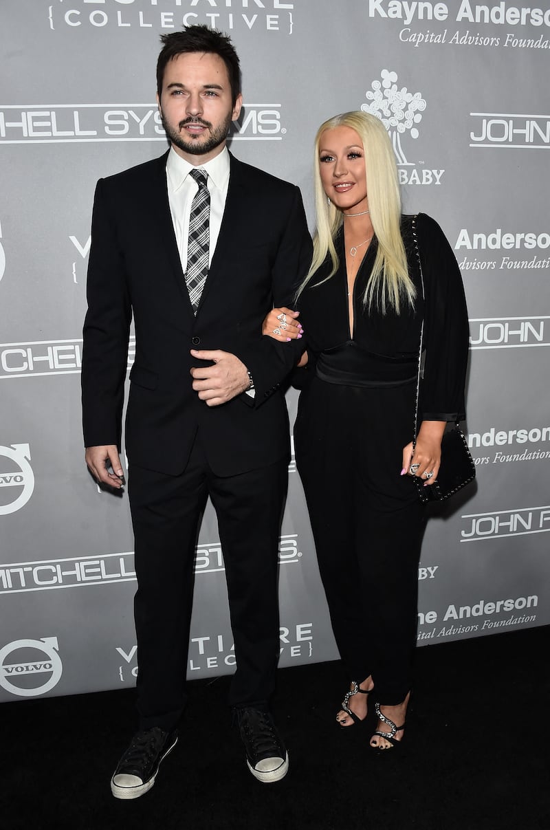 Matthew Rutler and Christina Aguilera, wearing a black  Emanuel Ungaro jumpsuit, attends the 5th Annual Baby2Baby Gala on November 12, 2016 in California. AFP