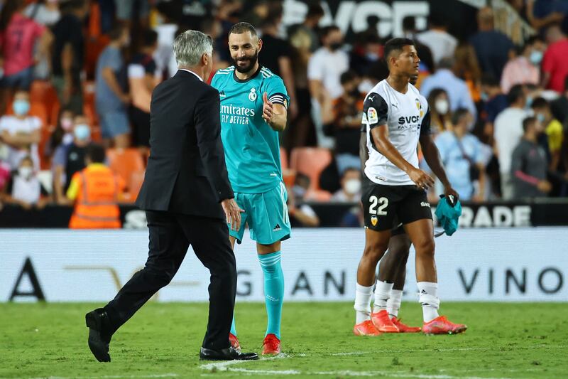 Carlo Ancelotti and Karim Benzema celebrate Real Madrid's win over Valencia. AFP