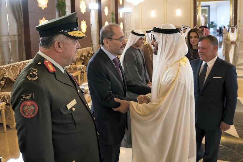 1ABU DHABI, UNITED ARAB EMIRATES - February 07, 2018: HH Sheikh Mohamed bin Zayed Al Nahyan Crown Prince of Abu Dhabi Deputy Supreme Commander of the UAE Armed Forces (R), greets  HE Ayman Safadi, Minister of Foreign Affairs of Jordan (2nd L), during a reception for HM King Abdullah II, King of Jordan (back R), at the Presidential Airport. Seen with HM Queen Rania Al Abdullah, Queen of Jordan (back). 

( Hamad Al Kaabi / Crown Prince Court - Abu Dhabi )
—