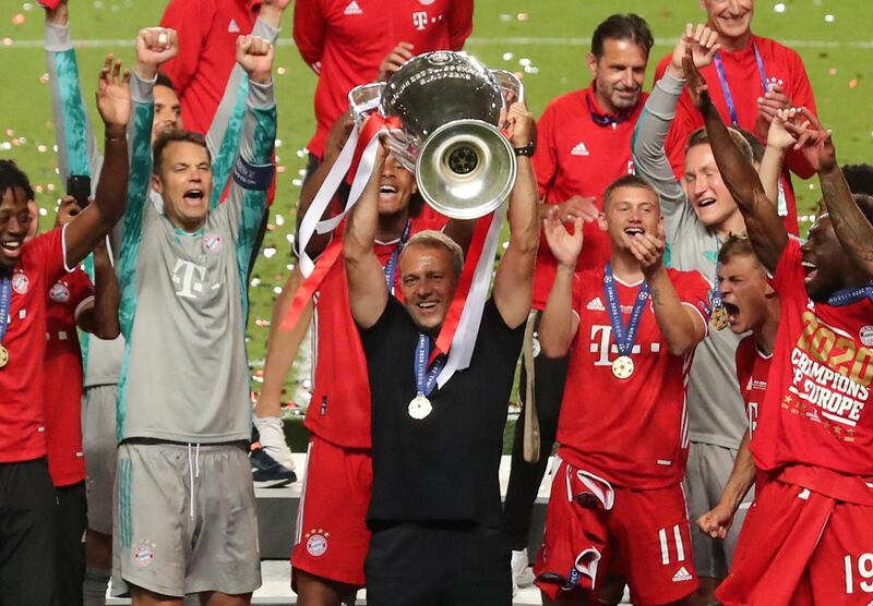 Bayern Munich coach Hansi Flick lifts the trophy. Reuters