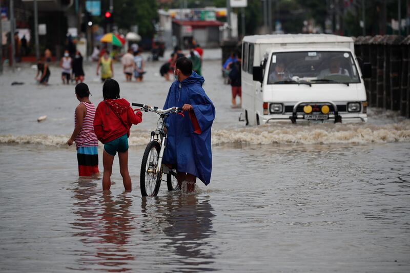 In some parts of Manila, flood waters cut off roads to light vehicles.