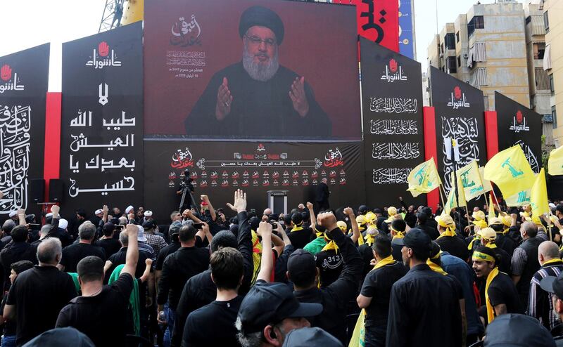 FILE PHOTO: Lebanon's Hezbollah leader Sayyed Hassan Nasrallah gestures as he addresses his supporters via a screen during the religious procession to mark the Shi'ite Ashura ceremony, in Beirut, Lebanon September 10, 2019. REUTERS/Aziz Taher -/File Photo