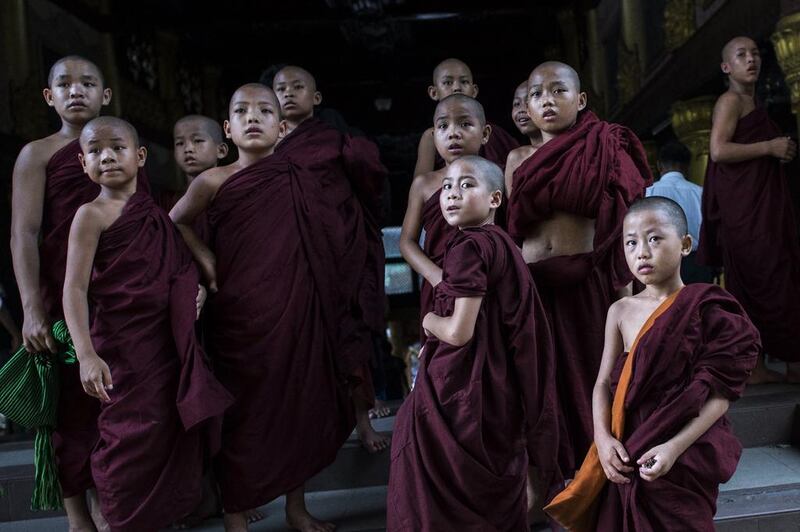 Buddhist novices watch the ninth anniversary of Saffron Revolution ceremony at Shwedagon pagoda in Yangon. The Saffron Revolution is a protest led by tens of thousands of monks against high fuel prices that took place in 2007 in Yangon. AFP