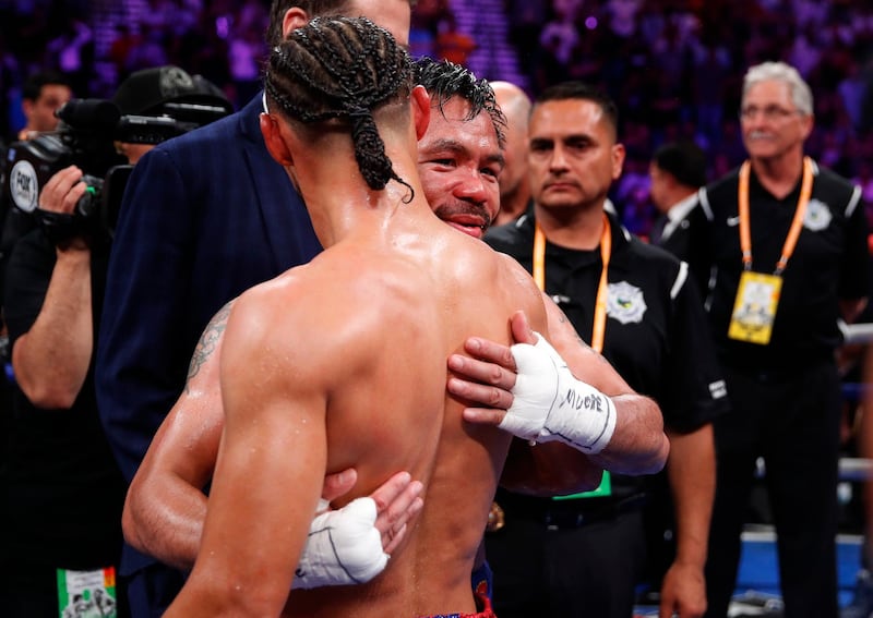 Manny Pacquiao hugs Keith Thurman after winning their welterweight title fight by split decision. AP Photo