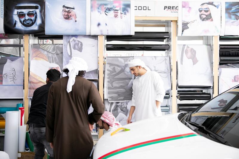 ABU DHABI, UNITED ARAB EMIRATES - NOVEMBER 27, 2018. 

Male university students shop for UAE National day accessories at Grand Plus Auto Accessories.

Car accessory shops in Mussafah are keeping busy as motorists rush to dress up their vehicles ahead of the UAE's 47th National Day.

(Photo by Reem Mohammed/The National)

Reporter:  HANEEN DAJANI
Section:  NA