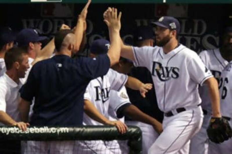 ST PETERSBURG, FL - OCTOBER 23: Dan Wheeler #35 of the Tampa Bay Rays is greeted by teammates as he walks back to the dugout after being relieved by David Price #14 in the top of the seventh inning against the Philadelphia Phillies during game two of the 2008 MLB World Series on October 23, 2008 at Tropicana Field in St. Petersburg, Florida.   Elsa/Getty Images/AFP

== FOR NEWSPAPERS, INTERNET, TELCOS & TELEVISION USE ONLY == *** Local Caption ***  551541-01-08.jpg