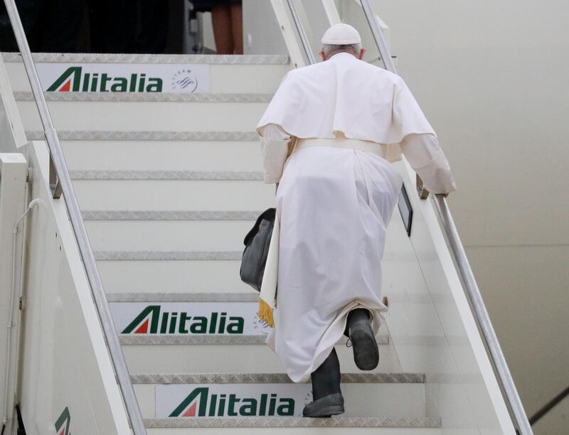Pope Francis boards his plane as he leaves from Fiumicino's International airport Leonardo da Vinci, near Rome, for Baghdad, Iraq, Friday, March 5, 2021. Pope Francis is bound to Iraq for a four-day visit to urge the country's dwindling number of Christians to stay put and help rebuild the country after years of war and persecution, brushing aside the coronavirus pandemic and security concerns to make the first-ever papal visit. (AP Photo/Gregorio Borgia).