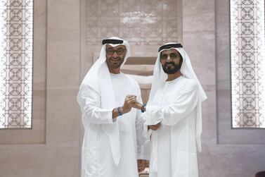 Sheikh Mohammed bin Rashid and Sheikh Mohamed bin Zayed meet in the Vice President's wing of Qasr Al Watan earlier this month to sport Expo 2020 wristbands. The two leaders and 500 other top government officials are meeting in in the capital on Monday. Mohamed Al Hammadi / Ministry of Presidential Affairs