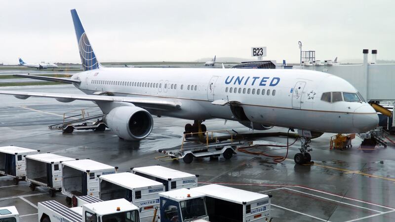 (FILES) In this file photo a United Airlines plane is parked at the gate on April 23, 2019, at Boston Logan International Airport. United Airlines said September 2, 2020 it plans to lay off up to 16,000 workers starting in October amid a prolonged industry downturn due to the coronavirus. The big US carrier, which had previously said as many as 36,000 workers could be terminated, said early retirement and other programs had lessened the need for even deeper cuts, but that the "devastating" impact of Covid-19 on airline travel still required layoffs. / AFP / Daniel SLIM
