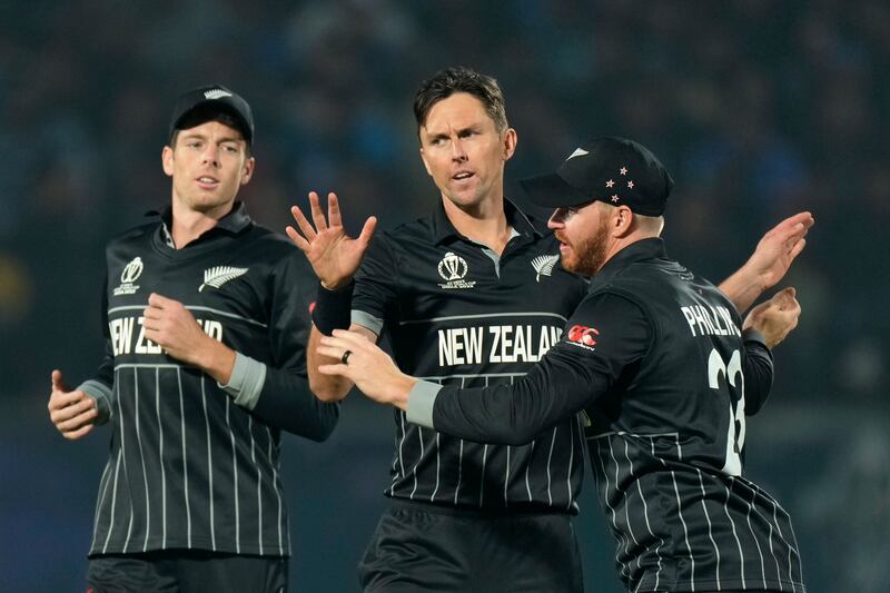 New Zealand's Trent Boult, centre, celebrates with teammates after taking the wicket of India's Shreyas Iyer. AP