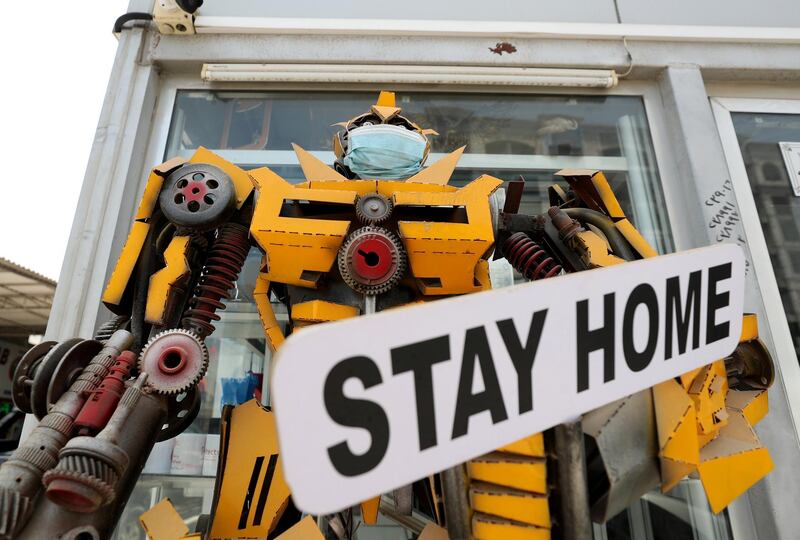 Ras Al Khaimah, United Arab Emirates - Reporter: N/A. Standalone. A model of a transformer robot wears a mask and carries a sign saying 'Stay home' outside a shop in Ras Al Khaimah. Tuesday, August 25th, 2020. Ras Al Khaimah. Chris Whiteoak / The National