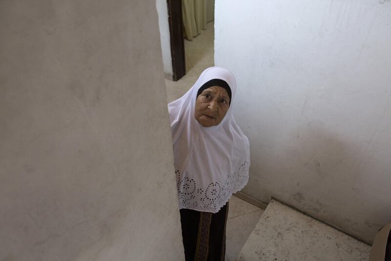 Fatima Shamasneh looks towards the street from the stairs of her her tiny basement  home in the East Jerusalem neighborhood of Sheik Jarrah on August 11,2017.

When thehamasne family first moved into their home  in the 1960s, East Jerusalem was controlled by Jordan and their monthly rent was paid to  Jordanian authorities but since  Israel annexed East Jerusalem in 1967, the Shamasne family has paid their rent to Israel's general custodian in order to remain in the building.
The family claims that their payments were suddenly rejected in 2009 , and they were informed that the property had been claimed by Israeli Jews whose ancestors had lived there decades previously.Although the family has spent years fighting to remain in the home , the Israeli high court has ruled that the family must evacuate the home before August 9. (Photo by Heidi Levine for The National).