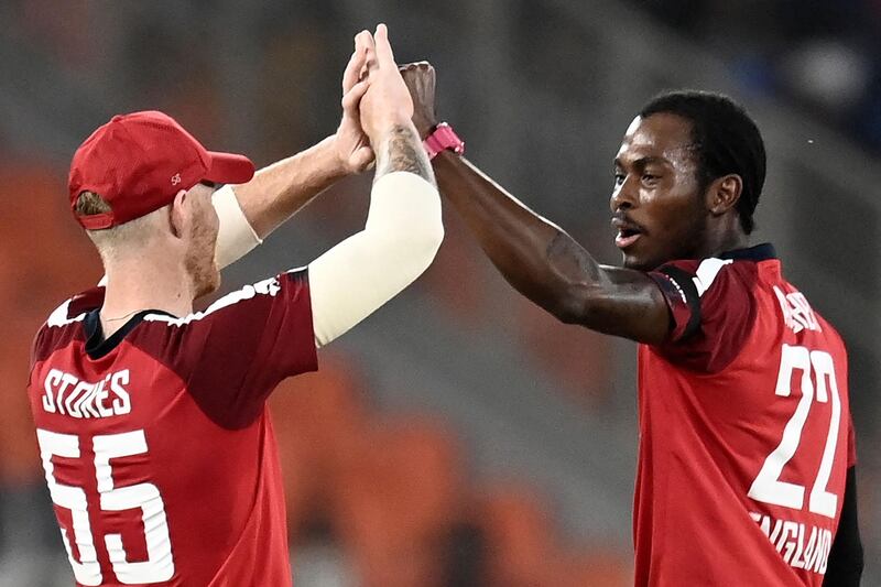 England's Jofra Archer (R) celebrates with Ben Stokes after taking the wicket of India's Shardul Thakur during the first Twenty20 at the Narendra Modi Stadium in Motera. AFP