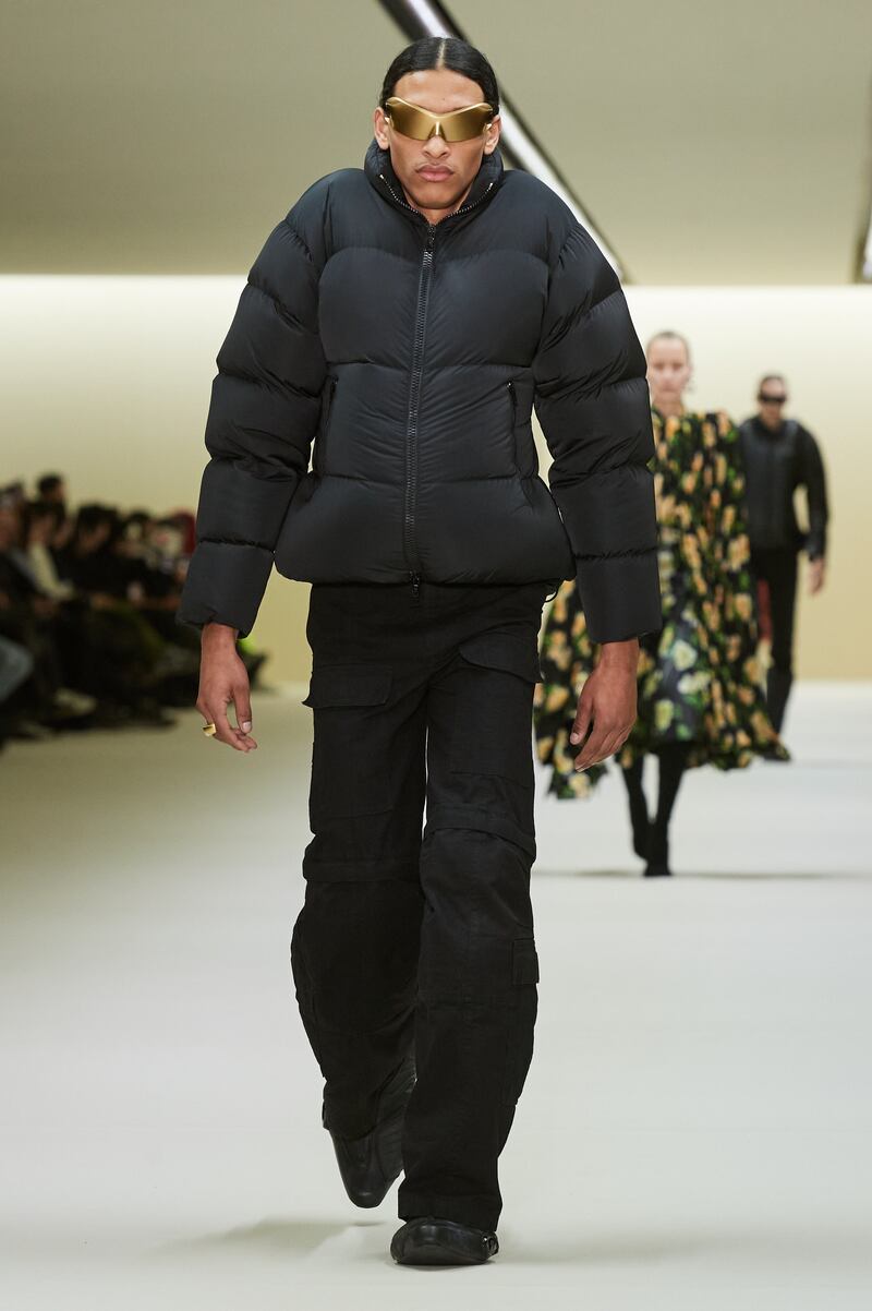 A puffer jacket pulled up high on the shoulders