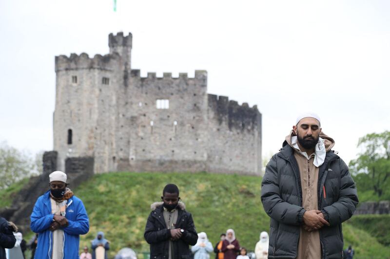 People gather to perform the Eid Al Fitr prayer outside Cardiff Castle in Wales. AFP