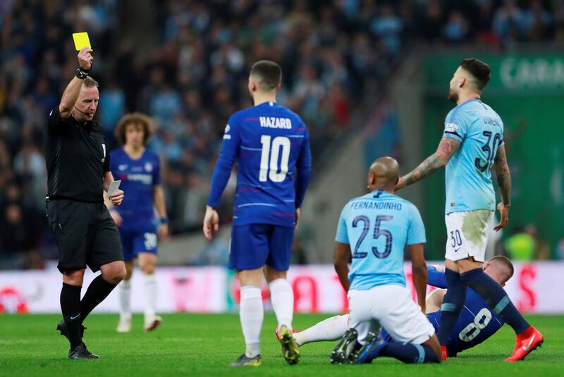 Manchester City's Fernandinho is shown a yellow card by referee Jonathan Moss. Action Images via Reuters