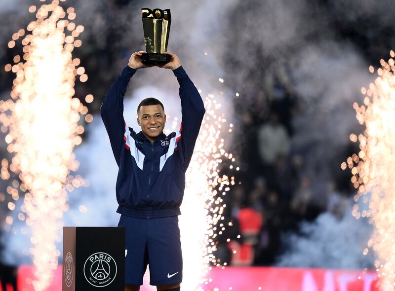  Kylian Mbappe raises a trophy during a ceremony after he became Paris Saint-Germain's all-time top scorer. AFP