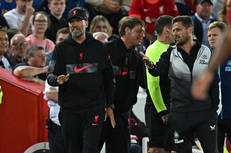 Liverpool manager Jurgen Klopp argues with Newcastle assistant coach Jason Tindall during the first half. AFP