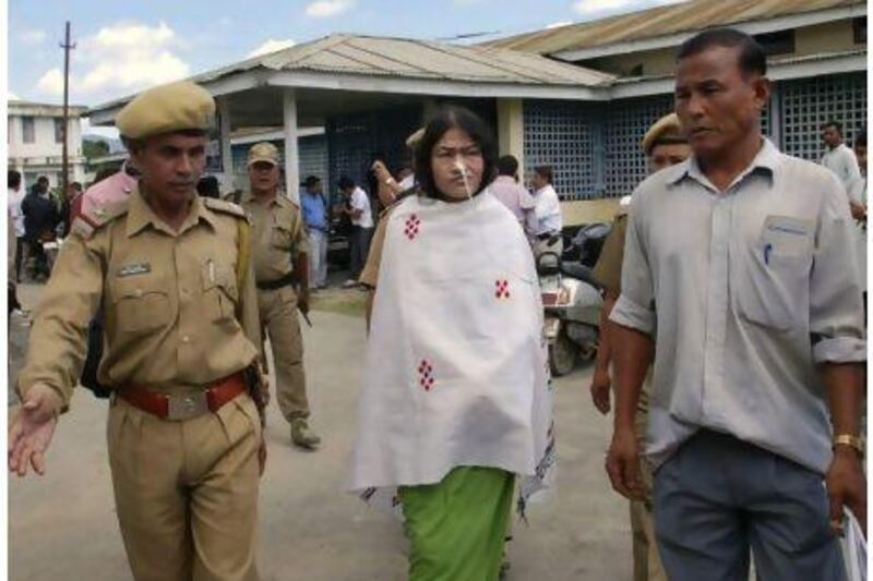 Irom Sharmila, centre, who has been on a decade-long hunger strike protesting against an anti-terror law that grants Indian soldiers sweeping powers in the northeastern state of Manipur, comes out after a court hearing in Imphal. Bullu Raj / AP Photo