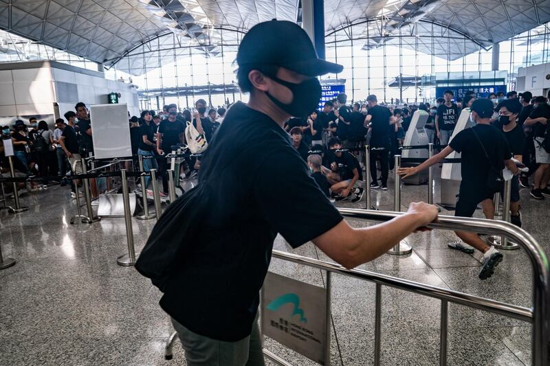 Protesters remove barricade at the departure hall of the Hong Kong International Airport during a demonstration in Hong Kong, China. Getty Images