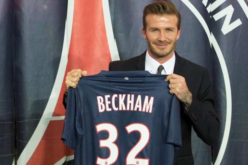 epa03563114 British football player David Beckham poses during a news conference to announce signing with Paris Saint Germain football club, at the Parc des Princes stadium in Paris, France, 31 January 2013.  EPA/IAN LANGSDON