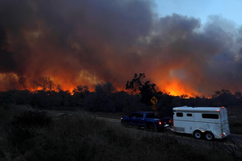 Retirement communities built on golf courses, semi-rural race horse stables and other usually serene sites were engulfed by flames. Mike Blake / Reuters