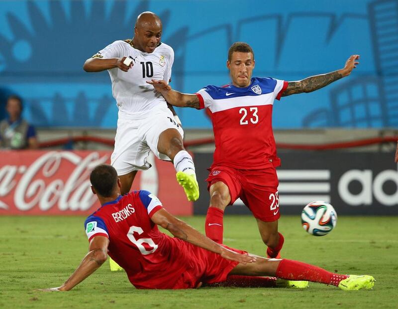 Andre Ayew, No 10, of Ghana shoots and scores past John Brooks and Fabian Johnson of the United States during their 2014 Fifa World Cup Group G match at Estadio das Dunas on June 16, 2014, in Natal, Brazil. Robert Cianflone / Getty Images