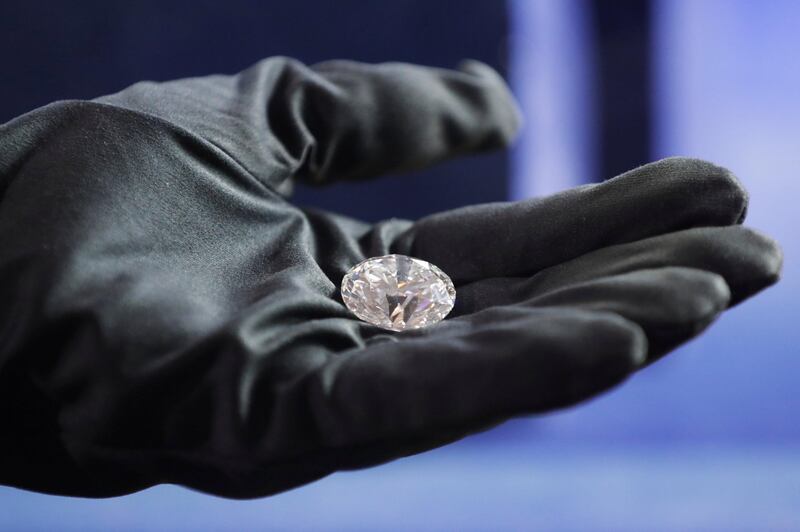 An employee shows the main 51.38-carat diamond during Russian miner Alrosa's presentation of the Dynasty polished diamonds collection in Moscow, Russia, August 1, 2017. REUTERS/Tatyana Makeyeva