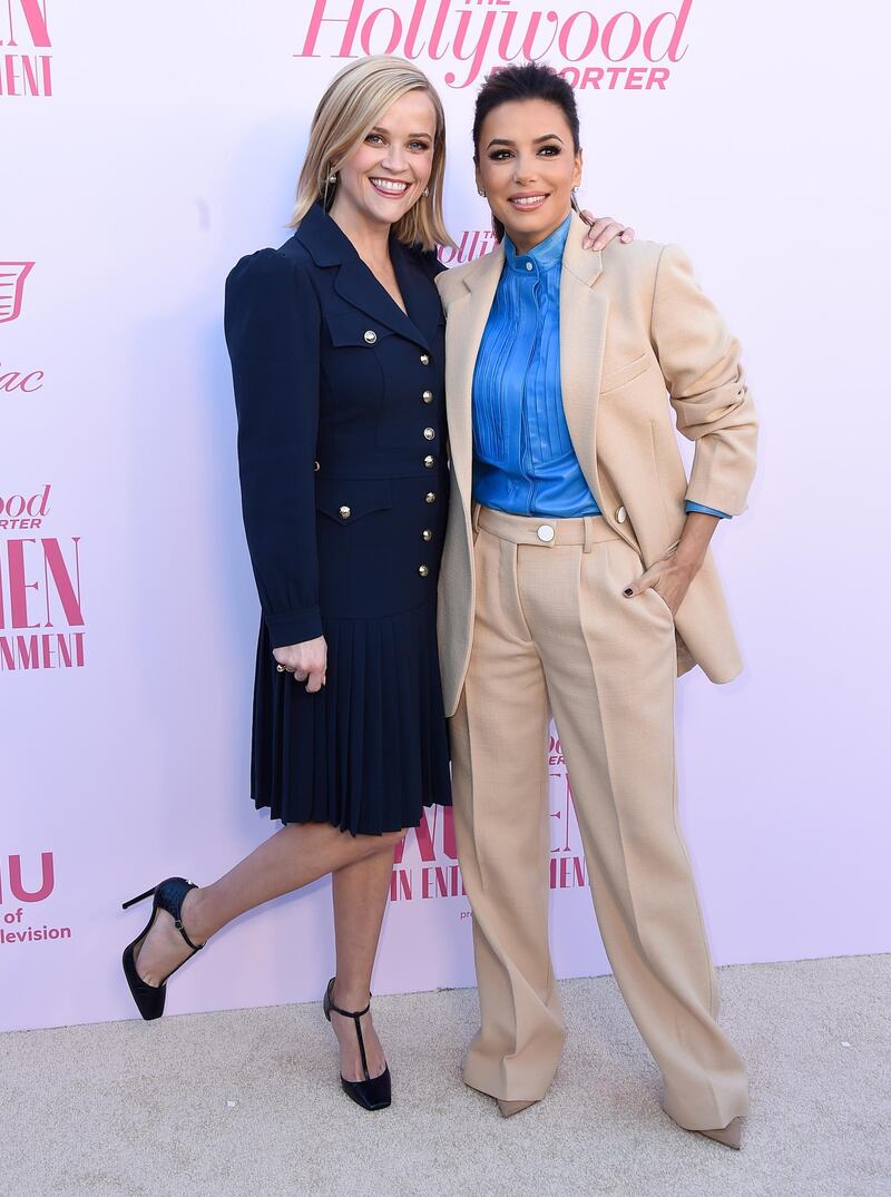 Reese Witherspoon, left, in Michael Kors, and Eva Longoria wearing Victoria Beckham at The Hollywood Reporter's Women in Entertainment Breakfast Gala. AP