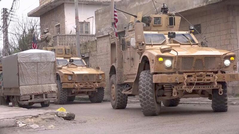 An image grab taken from a video obtained by AFPTV on January 16, 2019, shows US armoured vehicles at the scene of a suicide attack in the northern Syrian town of Manbij. 

 A suicide attack targeting US-led coalition forces in the flashpoint northern Syrian city of Manbij killed a US serviceman and 14 other people today, a monitor said.
 / AFP / -
