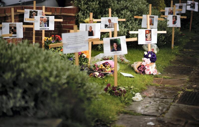 BURTON-ON-TRENT,  ENGLAND - APRIL 30: Photographs and memorials for those who died during the lockdown sit outside Riverside Church on April 30, 2020 in Burton-on-Trent, England.  The memorial garden has been set up by the church for people to pay their respects to those who have died from coronavirus and other illnesses during the pandemic lockdown. The 13 crosses includes three members from the same family, Jayne Harvey, 62, died from Covid-19 after nursing her parents Keith and Jean McVicar through the virus. British Prime Minister Boris Johnson, who returned to Downing Street this week after recovering from Covid-19, said the country needed to continue its lockdown measures to avoid a second spike in infections. (Photo by Christopher Furlong/Getty Images)