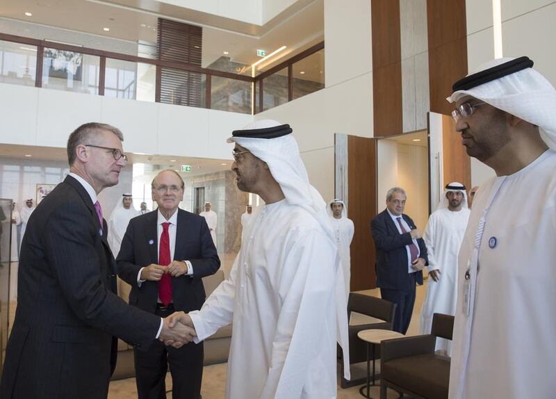 Sheikh Mohammed bin Zayed, Crown Prince of Abu Dhabi and Deputy Supreme Commander of the Armed Forces, centre, greets Mark Garrett, chief executive of Borealis, during roundtable discussions held by Adnoc ahead of Adipec. At right is Sultan Al Jaber, the Minister of State and chief executive of Adnoc. Mohammed Al Hammadi / Crown Prince Court – Abu Dhabi