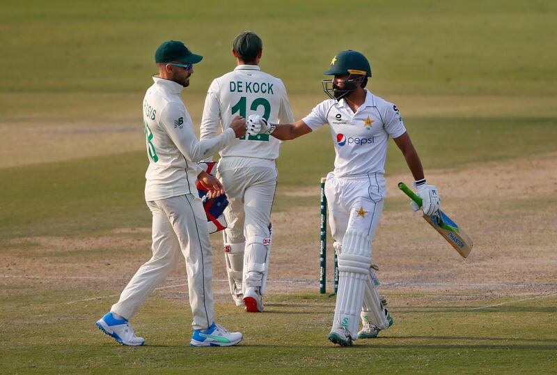 South Africa's Faf du Plessis, left, congratulates Fawad Alam after the Pakistan batsman completed his century. AP