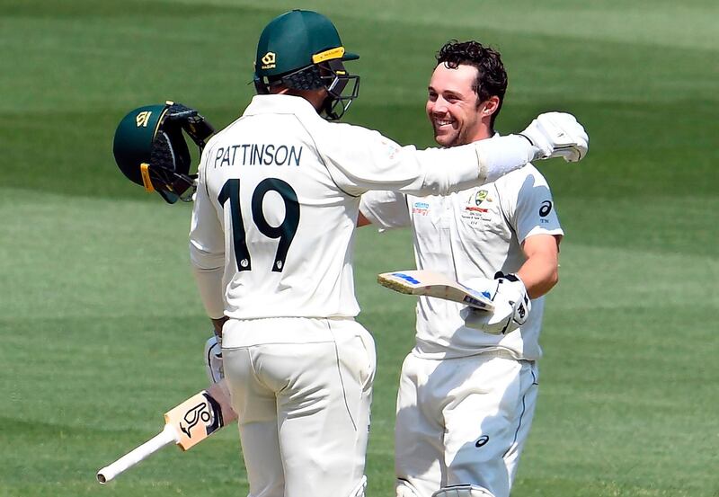 Australian batsman Travis Head celebrates with teammate James Pattinson after scoring his century against New Zealand on the second day of the second Test match in Melbourne on Friday. AFP