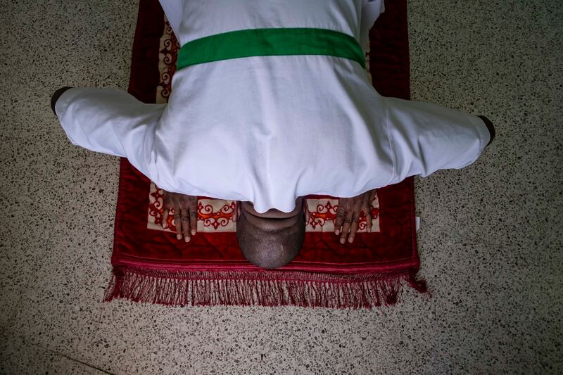 An inmate who converted to Islam three months ago prays at a jail in Dubai. All photos: Antonie Robertson / The National