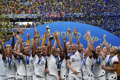 USA's players celebrate with the trophy after the France 2019 Women’s World Cup football final match between USA and the Netherlands, on July 7, 2019, at the Lyon Stadium in Lyon, central-eastern France. (Photo by FRANCK FIFE / AFP)