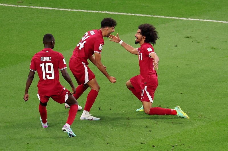 Qatar's Jassem Gaber celebrates scoring with Almoez Ali and Akram Afif. Getty Images