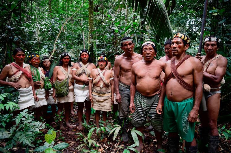 EDITORS NOTE: Graphic content / (FILES) In this file photo taken on April 24, 2019 Waorani indigenous people sing to thank nature at the Teata sacred waterfall, near the village of Nemompare, on the banks of the Curaray river, in Pastaza Province, Ecuador.  Ecuador reported the first case of the novel coronavirus COVID-19 among the Waorani indigenous people of the Amazon, on May 17, 2020, after a pregnant 17-year-old girl tested positive, according to the Ministry of Health. / AFP / Rodrigo BUENDIA
