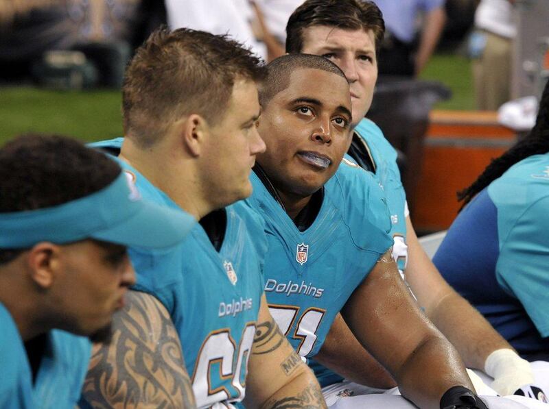Richie Incognito, left, and his racially-charged verbal harassment of teammate Jonathan Martin, right, have resulted in a scandal engulfing the Miami Dolphins. Bill Feig / AP