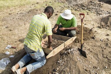 Abu Dhabi Tourism and Culture Authority archaeologist Omar Al Kaabi and a teammate sieve for finds on an archaeological excavation inside the 18th century Omani fort in Stone Town, Zanzibar.
