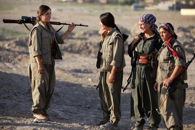 Female Kurdistan Workers Party (PKK) troops patrolling on the front line in the Makhmur area, near Mosul, during the ongoing conflict against ISIL militants. Ahmad Al Rubaye / AFP

