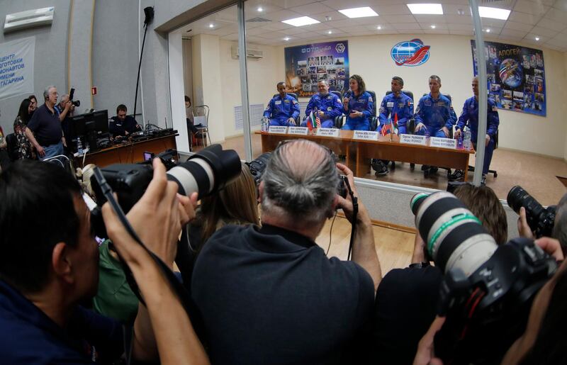 Television crews and photographers get a glimpse of the three astronauts and their reserve team. From left, Hazza Al Mansouri, Oleg Skripochka, Jessica Meir, Sultan Al Neyadi, Sergey Ryzhikov and Thomas Marshburn. AP Photo