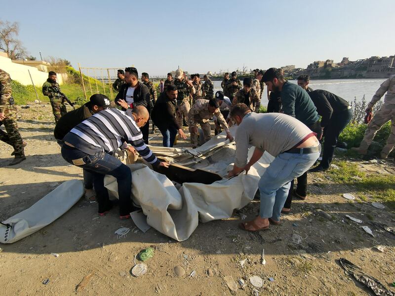 Iraqi rescues are seen near the site. Reuters
