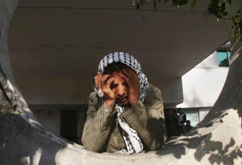 A Palestinian man holds his head in his hands as he reacts at the Shifa Hospital in Gaza City, Monday, Jan. 5, 2009. Israeli forces pounded Gaza Strip houses, mosques and smuggling tunnels on Monday from the air, land and sea, killing at least seven children as they pressed a bruising offensive against Palestinian militants. (AP Photo/Ashraf Amra) *** Local Caption ***  JRL318_APTOPIX_MIDEAST_ISRAEL_PALESTINIANS.jpg