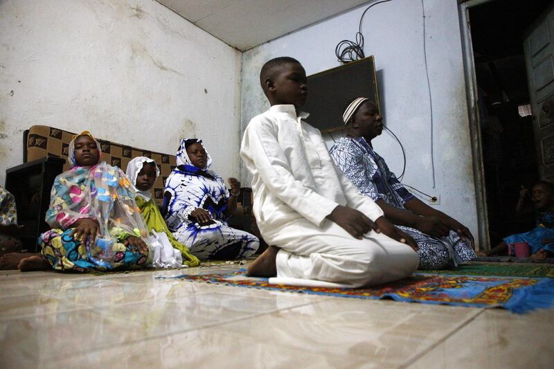 Kone Adama prays at home with his family during the Muslim holy month of Ramadan amid the ongoing coronavirus COVID-19 pandemic in Abidjan, Ivory Coast.  EPA