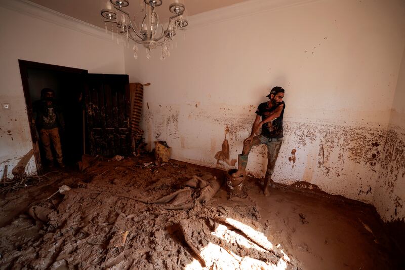 A flood survivor takes a breather from removing mud from his home in the aftermath of deadly floods in Derna. Reuters