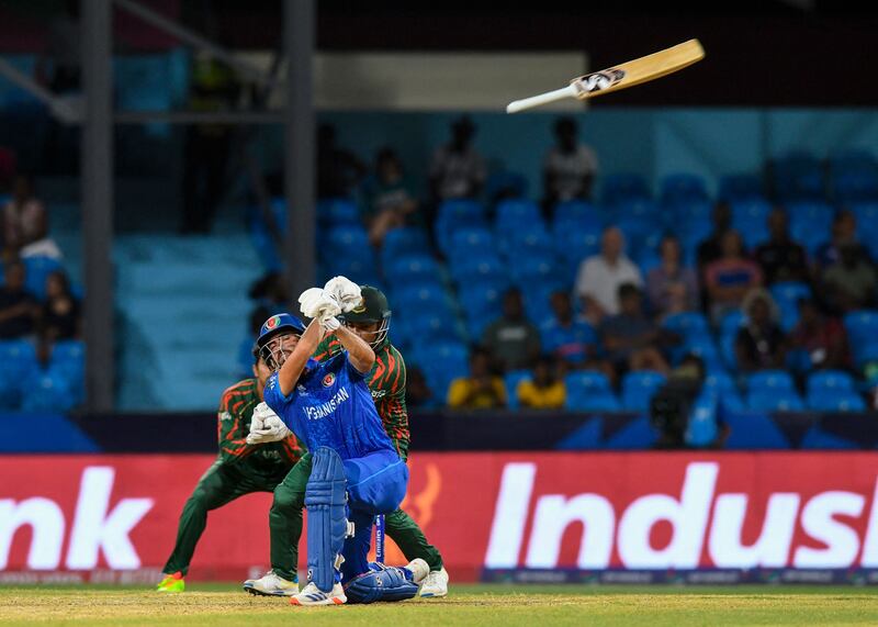 The bat slips out of the hands of Afghanistan's Ibrahim Zadran' while batting against Bangladesh. AFP