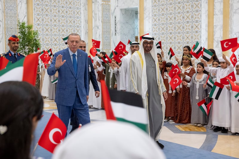 President Sheikh Mohamed and Mr Erdogan are welcomed by schoolchildren during an official reception at Qasr Al Watan. Photo: UAE Presidential Court