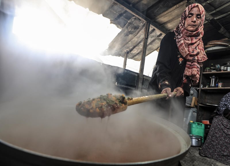 Amel Abu Amra prepares a meal. EPA