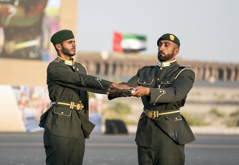 ZAYED MILITARY CITY, ABU DHABI, UNITED ARAB EMIRATES - November 28, 2017: HH Sheikh Hamdan bin Saeed bin Zayed Al Nahyan (L) swears the oath of allegiance during a graduation ceremony for the 8th cohort of National Service recruits and the 6th cohort of National Service volunteers at Zayed Military City. 
( Hamad Al Kaabi / Crown Prince Court - Abu Dhabi )
—